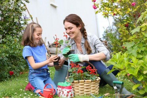 Professional gardeners following safe maintenance practices outdoors